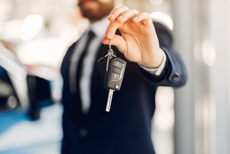 Man buying the car. Businessman in a car salon